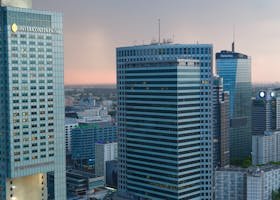 pexels-photo-6962235-6962235 Aerial view of modern skyscrapers in downtown Warsaw at dusk, featuring urban architecture.