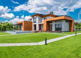 pexels-photo-7031600-7031600 Exterior of contemporary residential house with green yard and paths near forest in summer